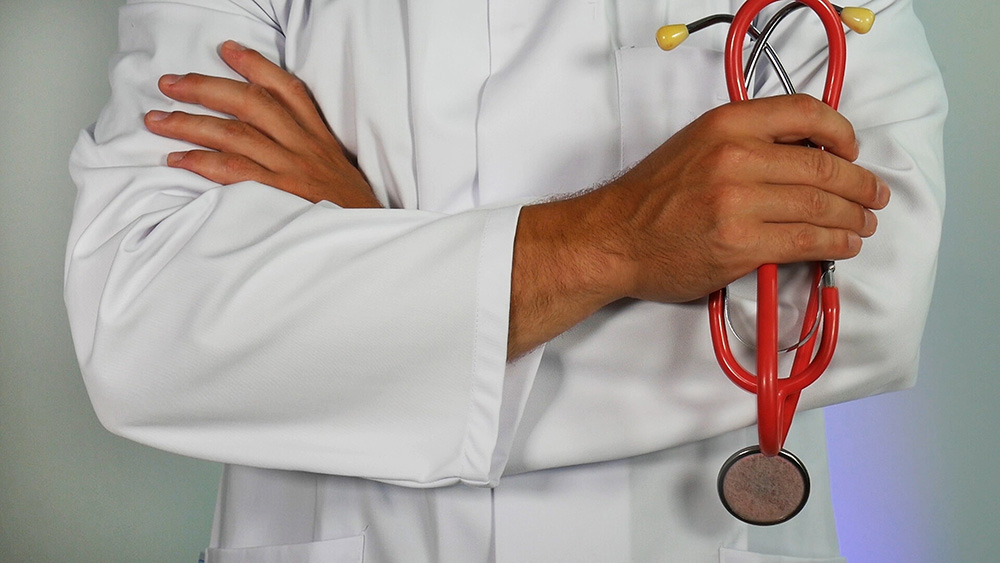 Close up of doctor with folded arms and holding a stethoscope